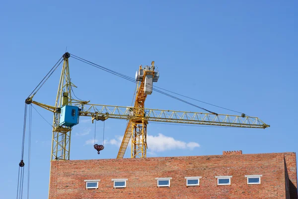 Tower cranes on blue sky background