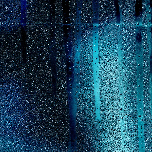 Moving water drops on the glass