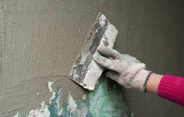 Hand with a trowel plaster wall
