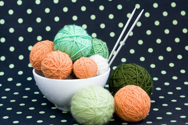 A lot of bright balls for knitting on a dark background