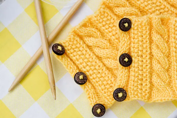 Yellow knitted pattern on a fabric