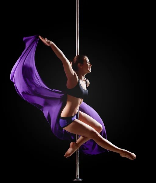 Girl show gymnastic exercise with pole dance