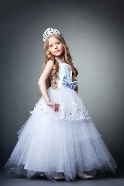 Pretty little girl in tiara and white dress