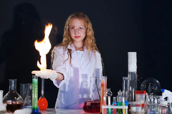 Curly girl shows science experiment in studio