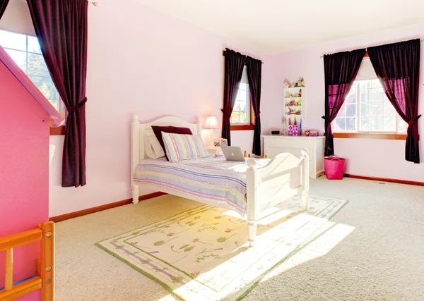 Pink girls bedroom interior with curtains and white bed.