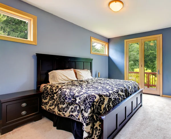 Blue modern bedroom with balcony door.