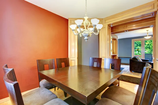 Dining room in red and blue and black table.