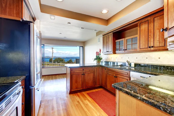 Apartment kitchen with water view and granite.