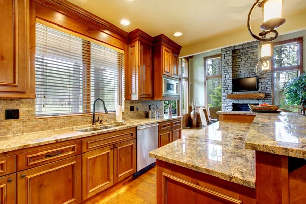 Luxury wood kitchen with granite countertop.