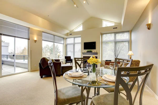 Large bright living and dining room with vaulted ceiling.