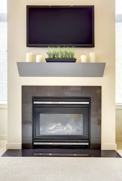 Modern new fireplace with large TV.