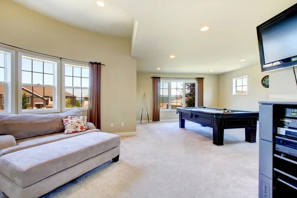 Large family room with pool table and tv.