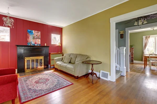Living room with red and yellow walls and fireplace.