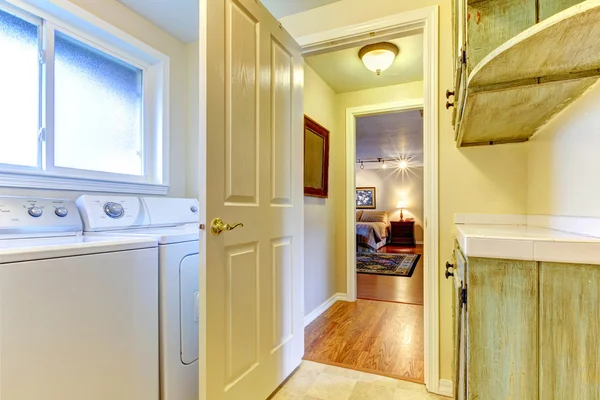 Laundry room with open door to bedroom.