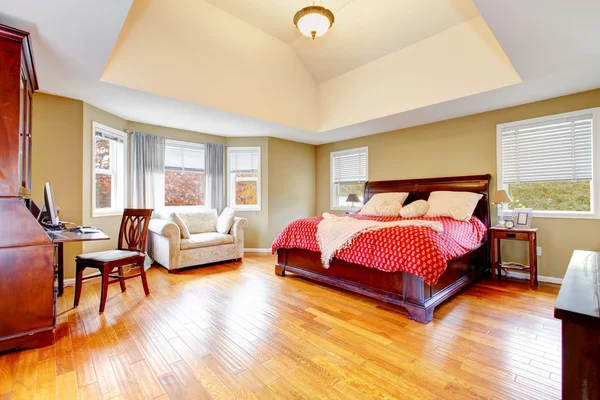 Large master bedroom interior with green alls and hardwood floor