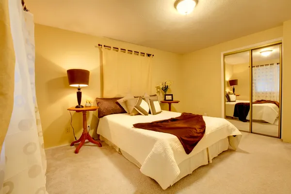 Elegant bright bedroom with walk-in closet