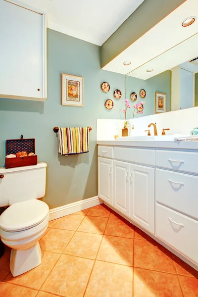 Bright cozy bathroom with white wood cabinets