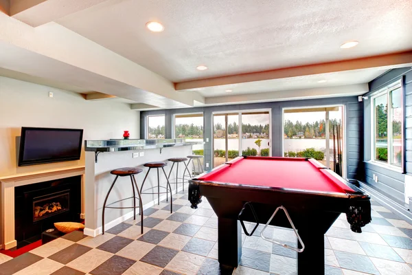 Elegant entertainment room with pool, bar and fireplace