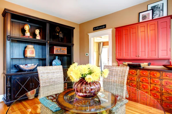 Charming dining room with glass dining table and wicker rustic c