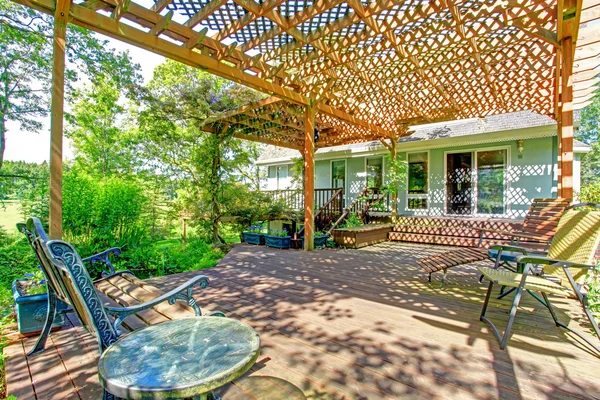 Backyard farm deck with attached open pergola