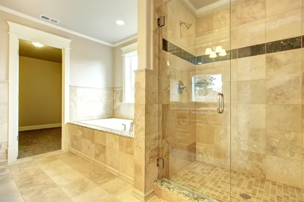 Cozy bathroom with tub and glass door shower