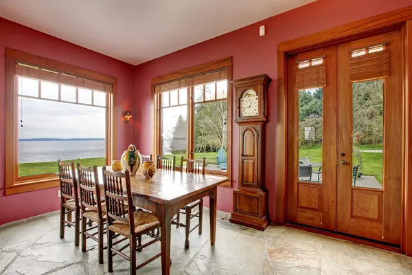 Burgundy dining room with antique grandfather clock