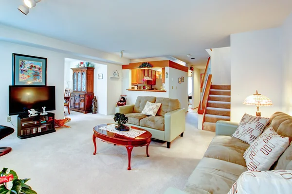 House interior. View of living room, staircase, kitchen and dini