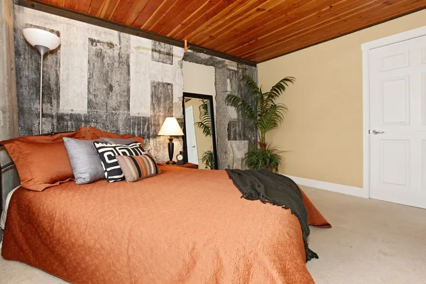 Modern bedroom with a broken concrete wall