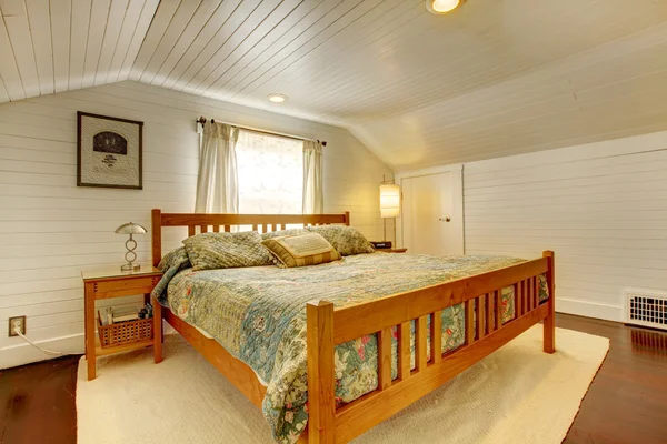 Wood plank paneled bedroom