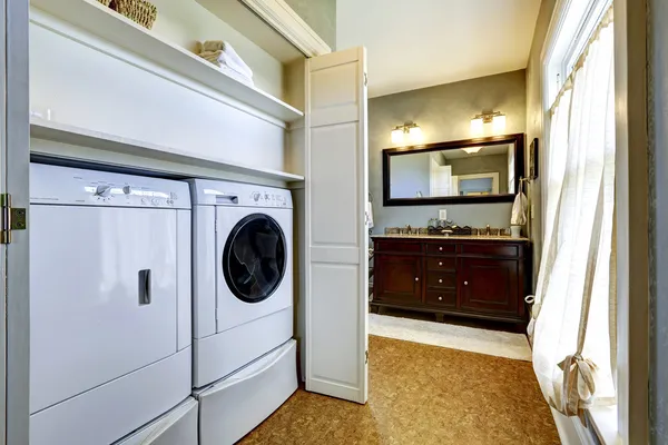 Light grey hallway with built-in washer and dryer