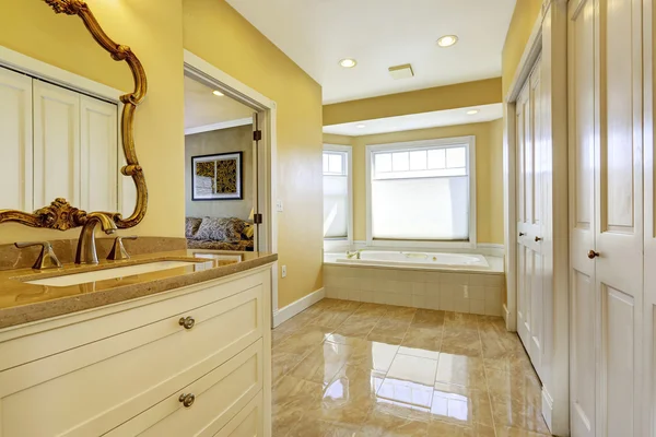 Bathroom with shiny tile floor in master bedroom