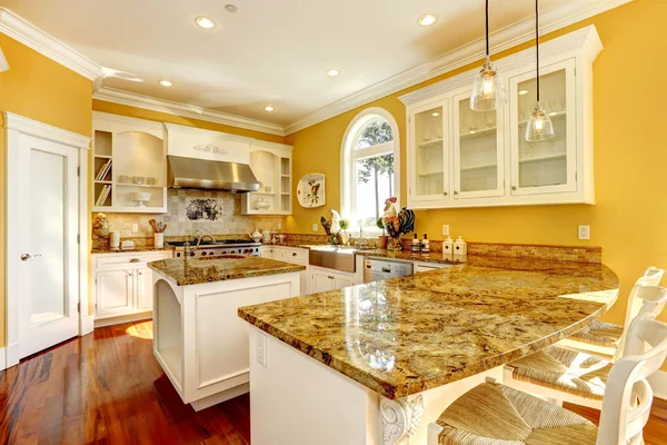 Bright yellow kitchen room with granite tops