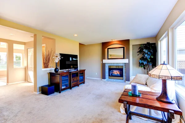 House interior with open floor plan. Living room with fireplace