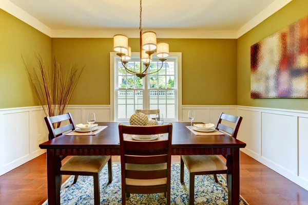 Green craftsman large dining room with cherry floor.