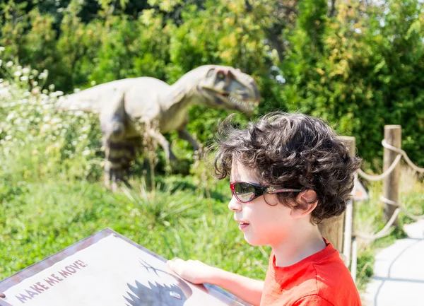 Young Hispanic Child Vising a Dinosaur Themed Park in Canada