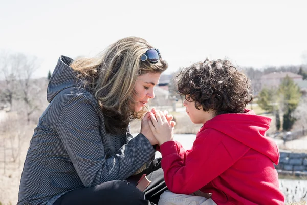 Small Family Praying Outdoors