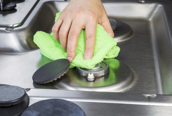 Cleaning stove top with microfiber cloth