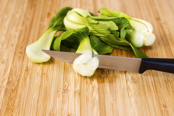 Asian Choy Vegetable been cut with Knife on Bamboo board