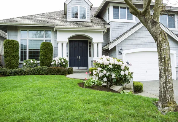 Residential home in Mid Spring Season with Blooming Flowers and