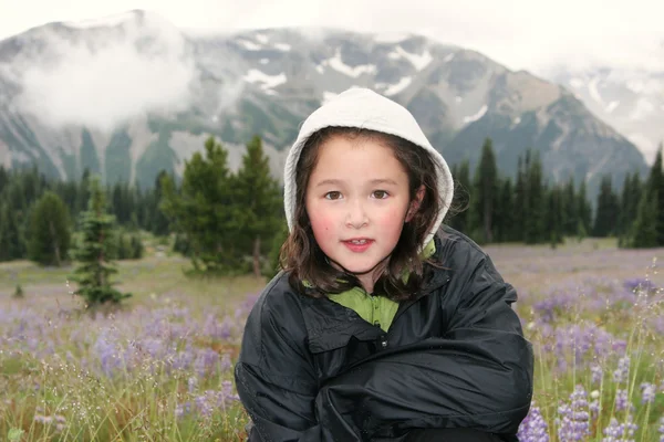 Young Girl hiking outdoors during early spring in the mountains