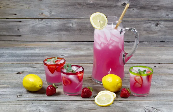 Large pitcher of lemonade with glassware