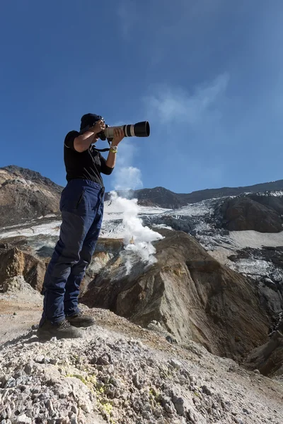 Photographer in the crater of active volcano