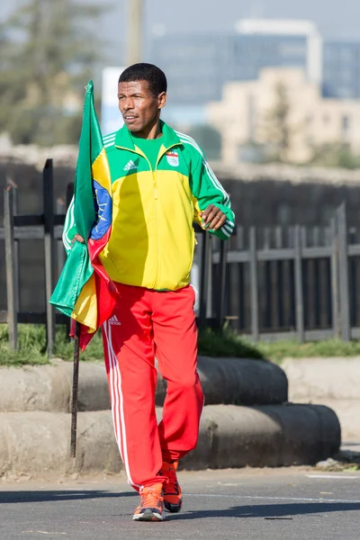 Haile Gebrselassie holding the Ethiopian Flag