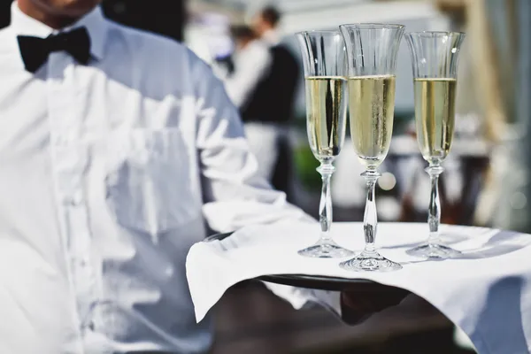Waiter serving champagne