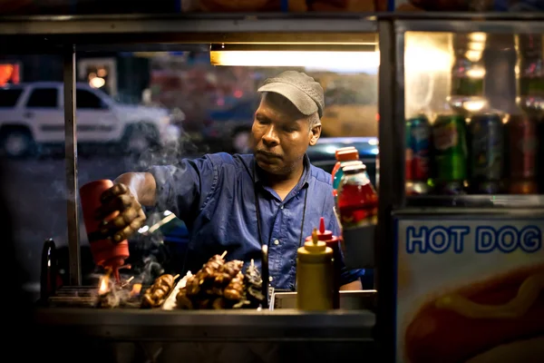 Male street vendor of hot dogs