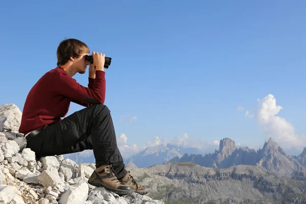 Searching the destination through binoculars in the mountains