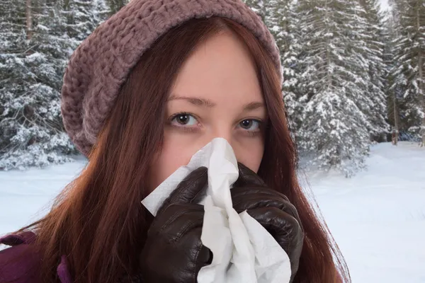 Young woman having a cold and flu virus outdoors
