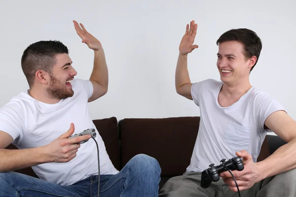 Young people winning while playing video games