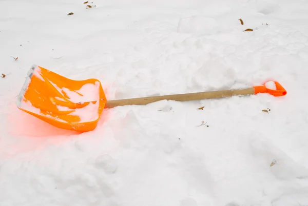 Orange snow clean tool lie rest snowdrift winter