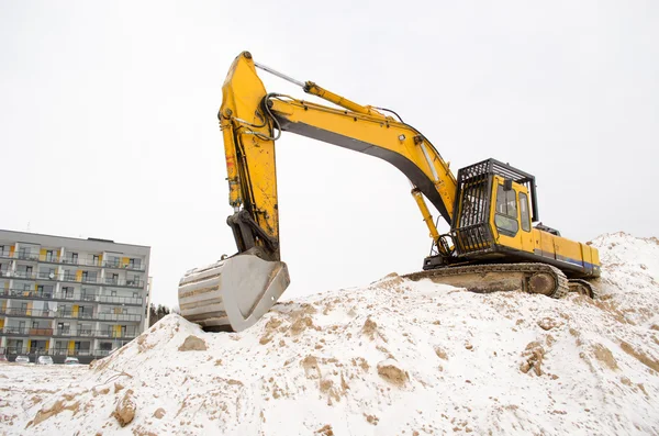 Excavator sand pit snow winter apartment house